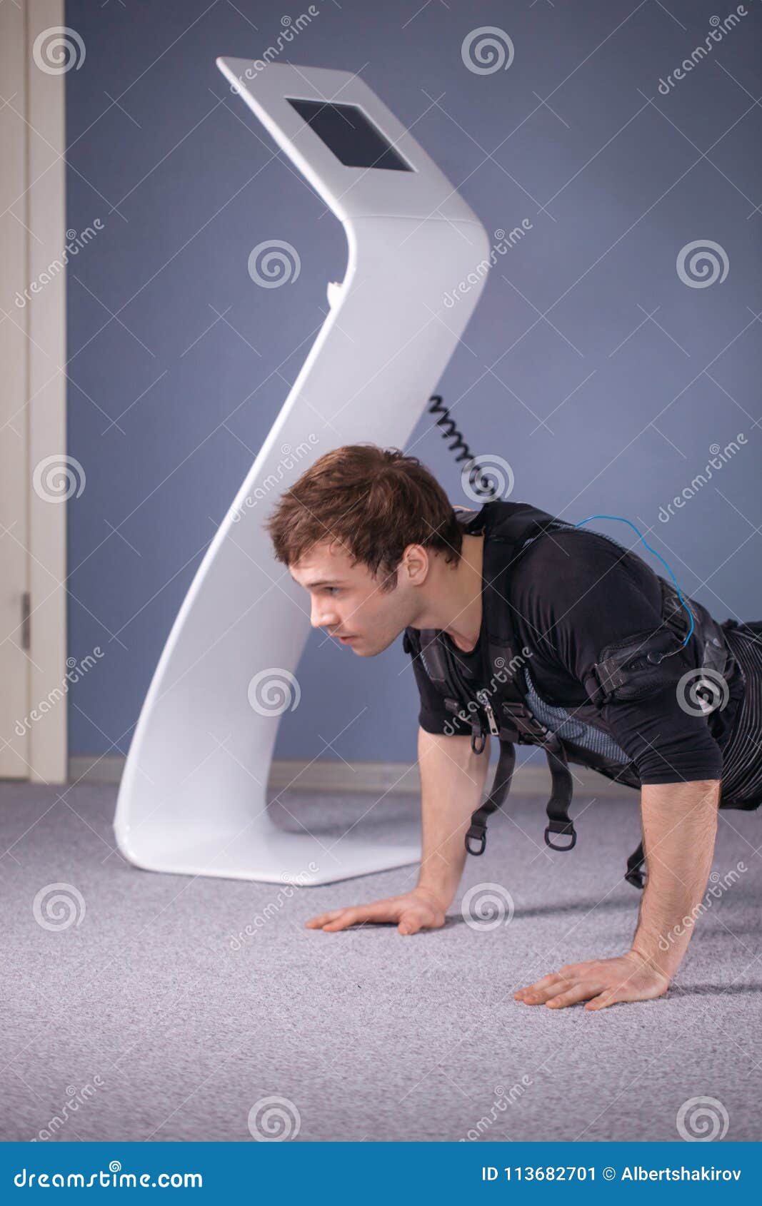 Man in Electrical Muscular Stimulation Suits Doing Plank Exercise. EMS