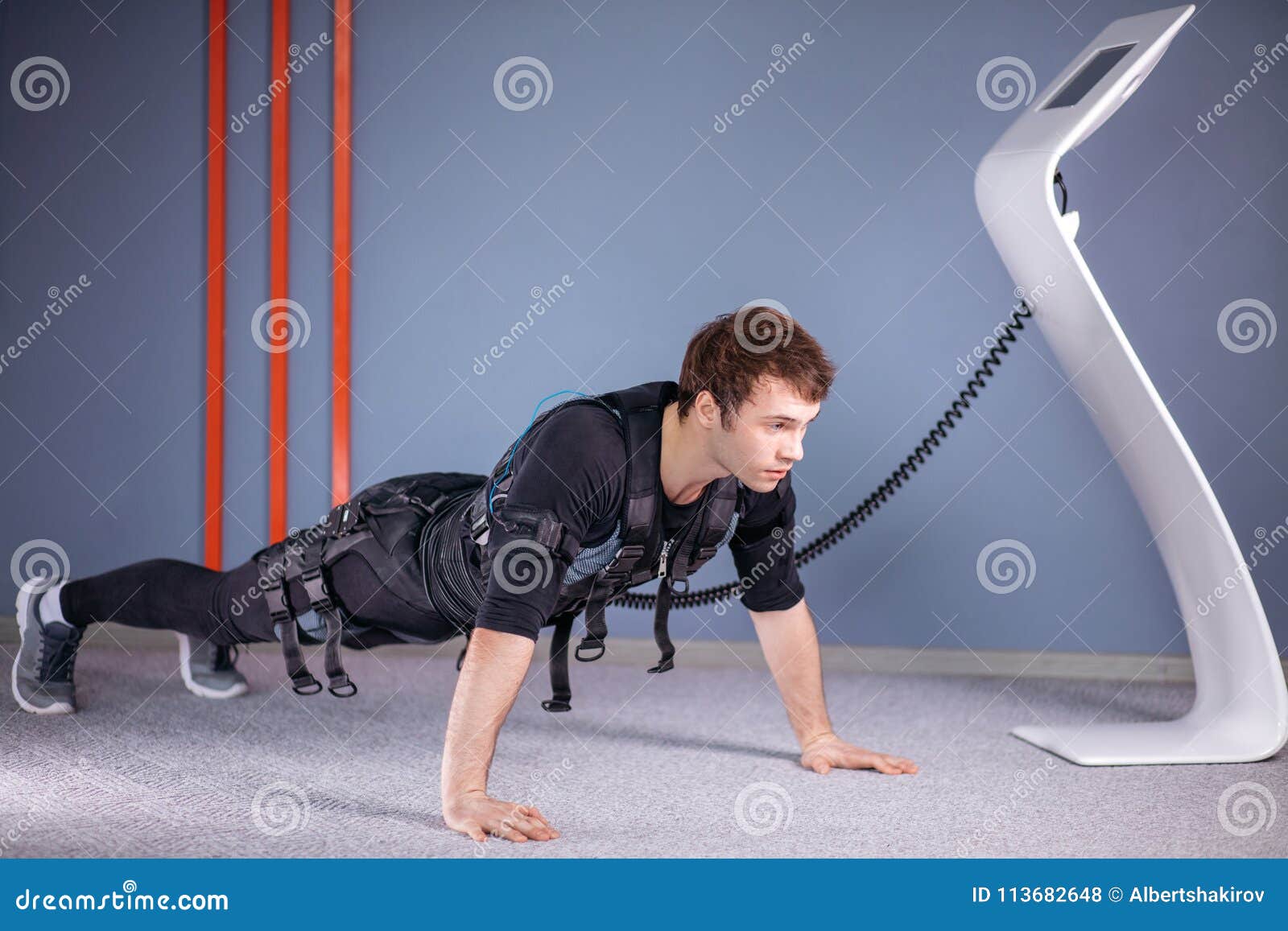 Man in Electrical Muscular Stimulation Suits Doing Plank Exercise. EMS
