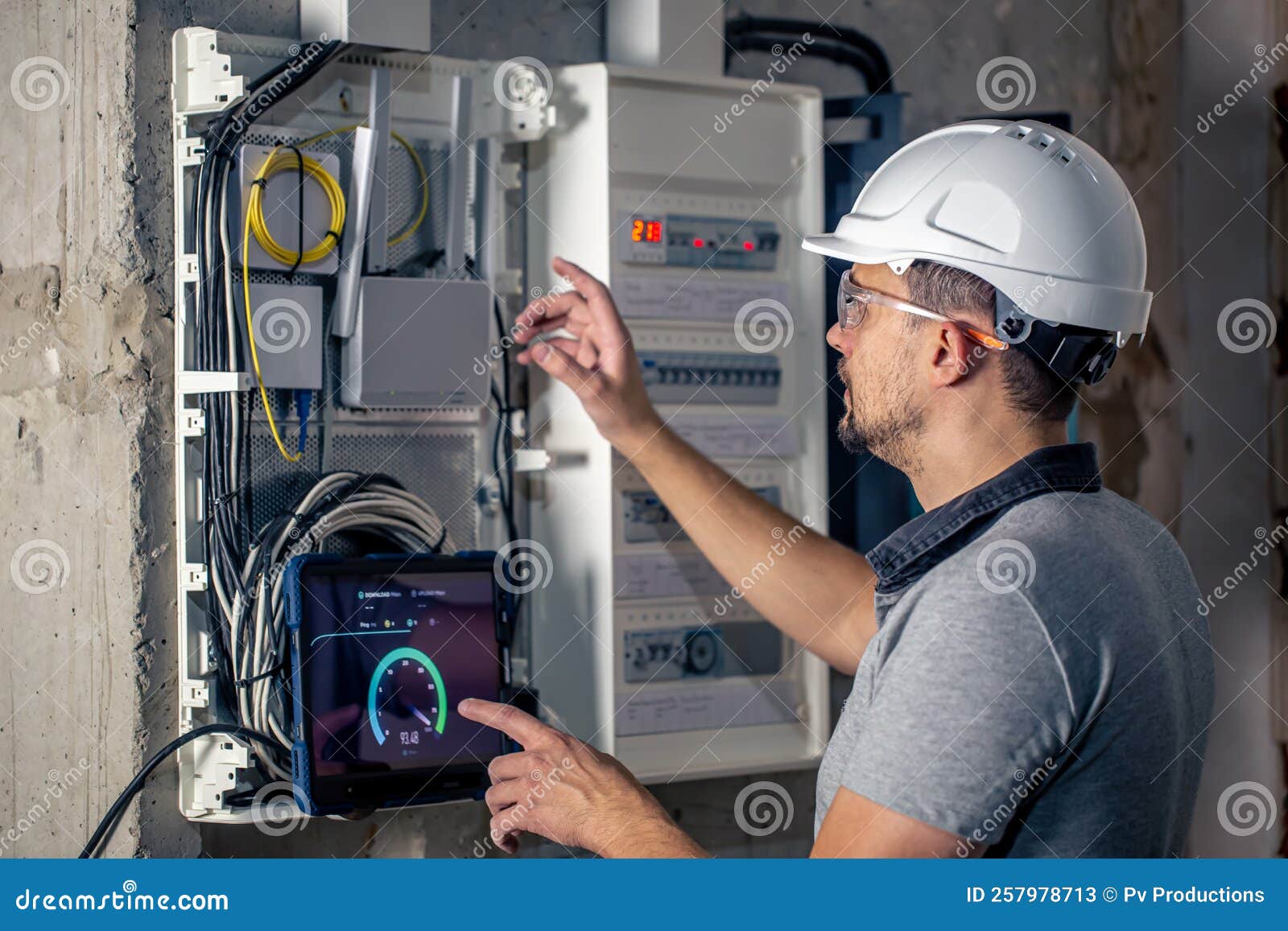 Man, an Electrical Technician Working in a Switchboard with Fuses, Uses