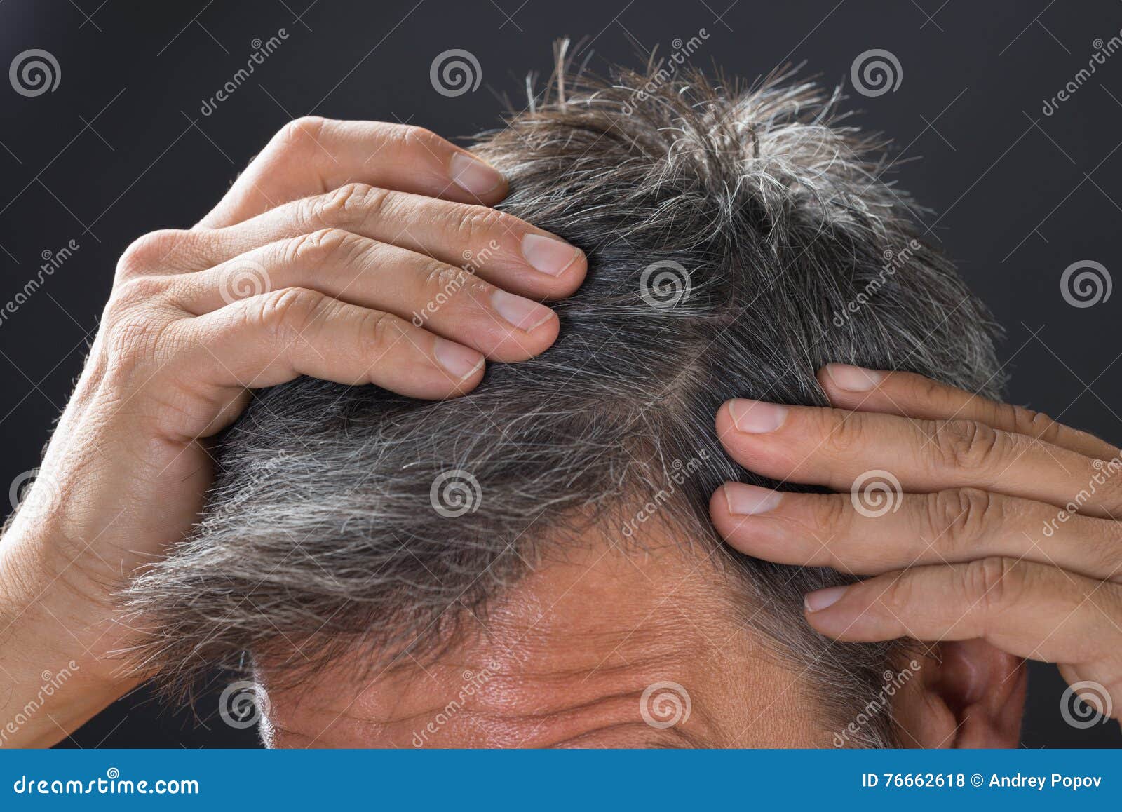 man examining his white hair