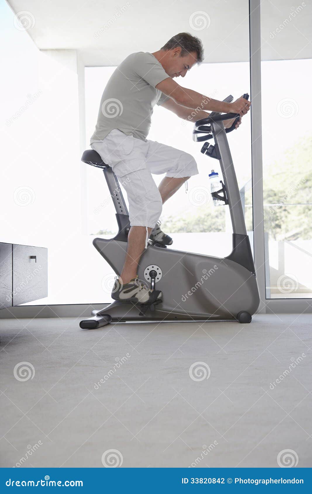 man on exercise bike pedaling at home