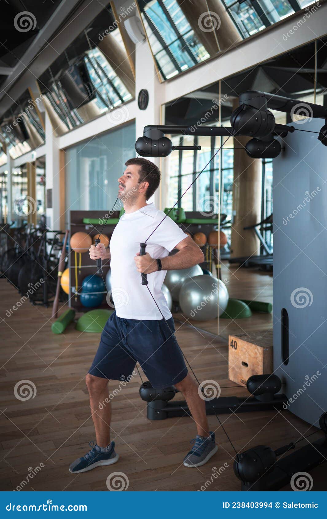 Man Exercising in the Gym on a Pec Deck Machine for Chest Workout Stock