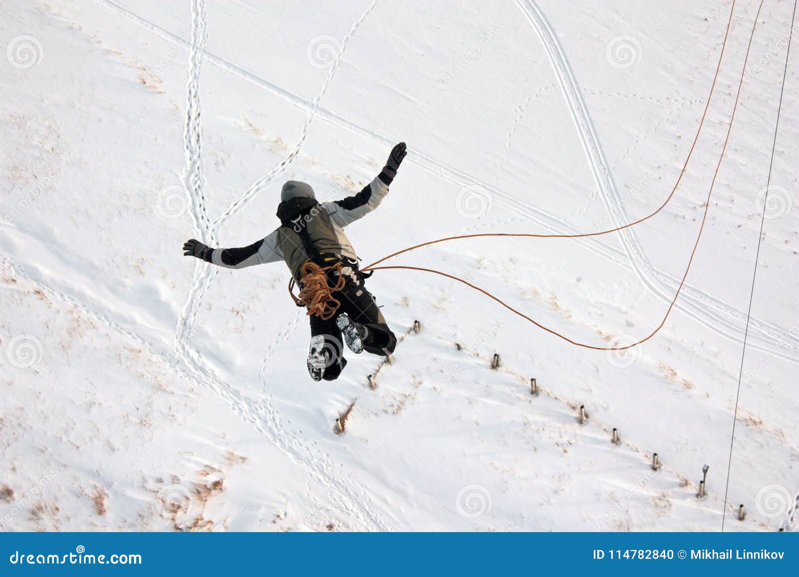 A Man Falls from a Height when Jumping with a Rope. Stock Photo Image