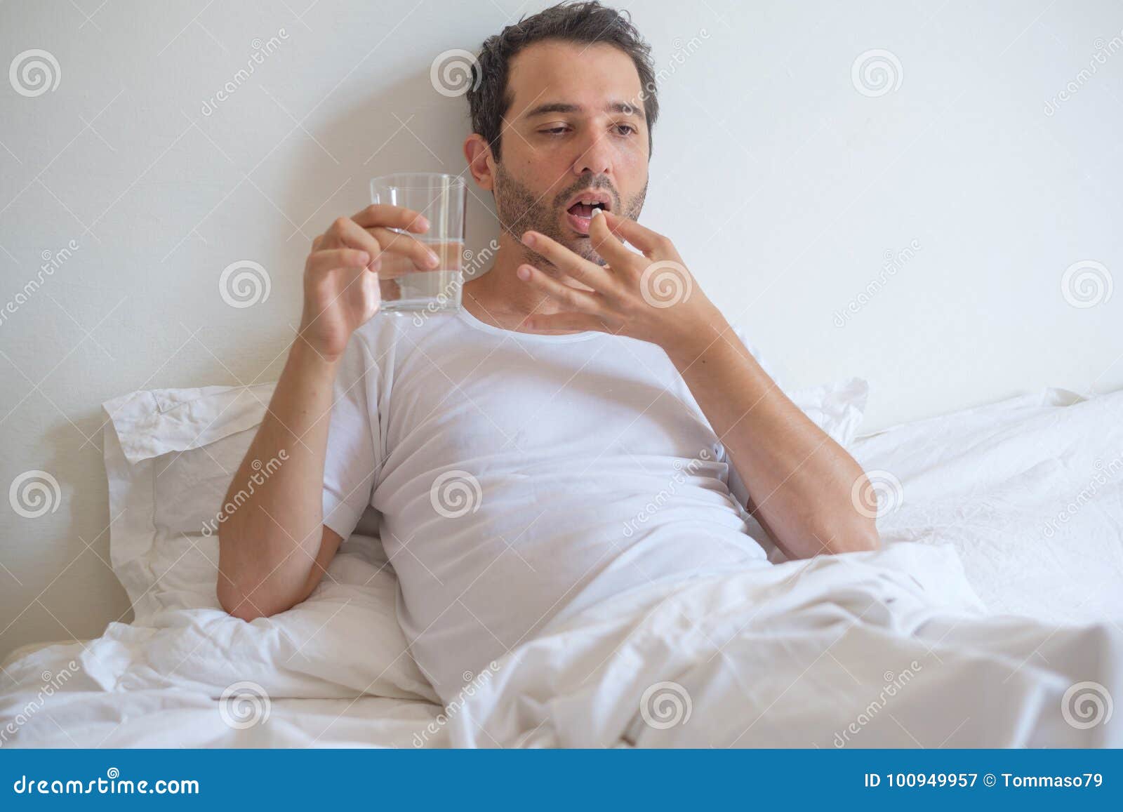 Man Feeling Sick and Taking Medicine Pills Lying in Bed Stock ...