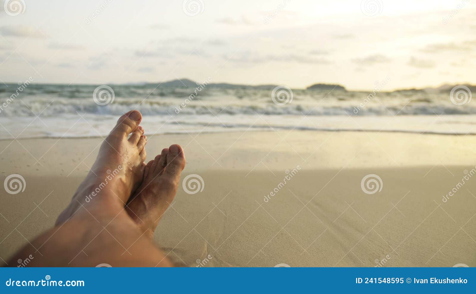 The Man Feet Relaxed are Lying on the Sandy Beach and Washed by Stock ...