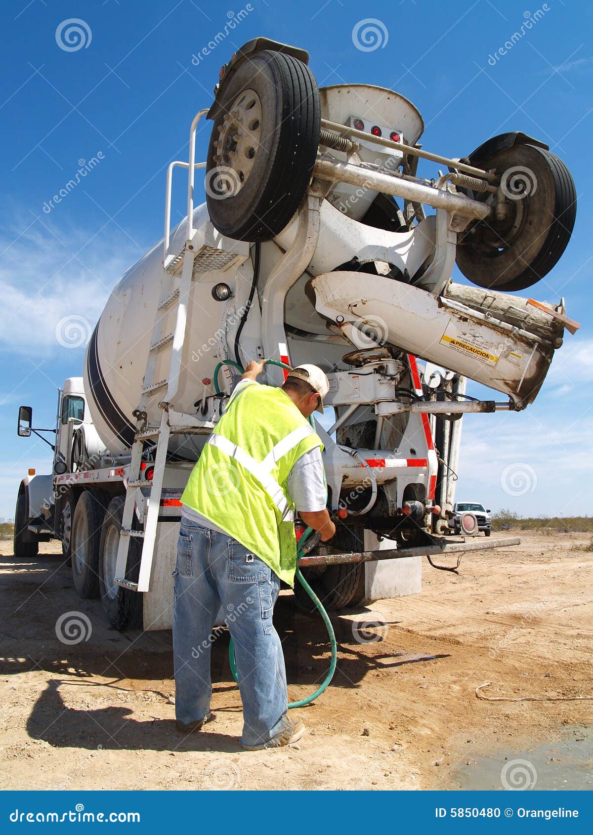 Man Fiddling with Hose on Cement Truck Vertical Stock Photo Image