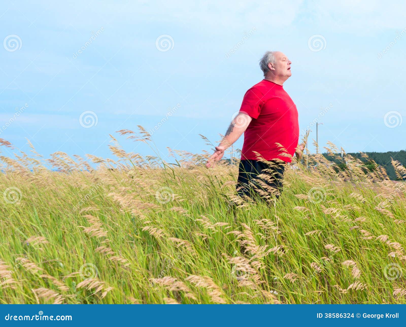 man in field with breeze