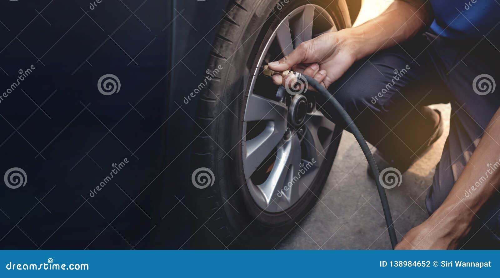 man filling air into the tire. car driver checking air pressure and maintenance his car by himself