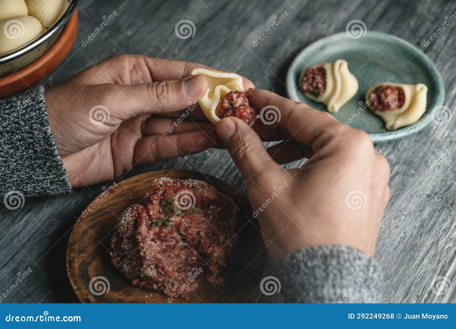 man is filling a catalan galet with ground meat