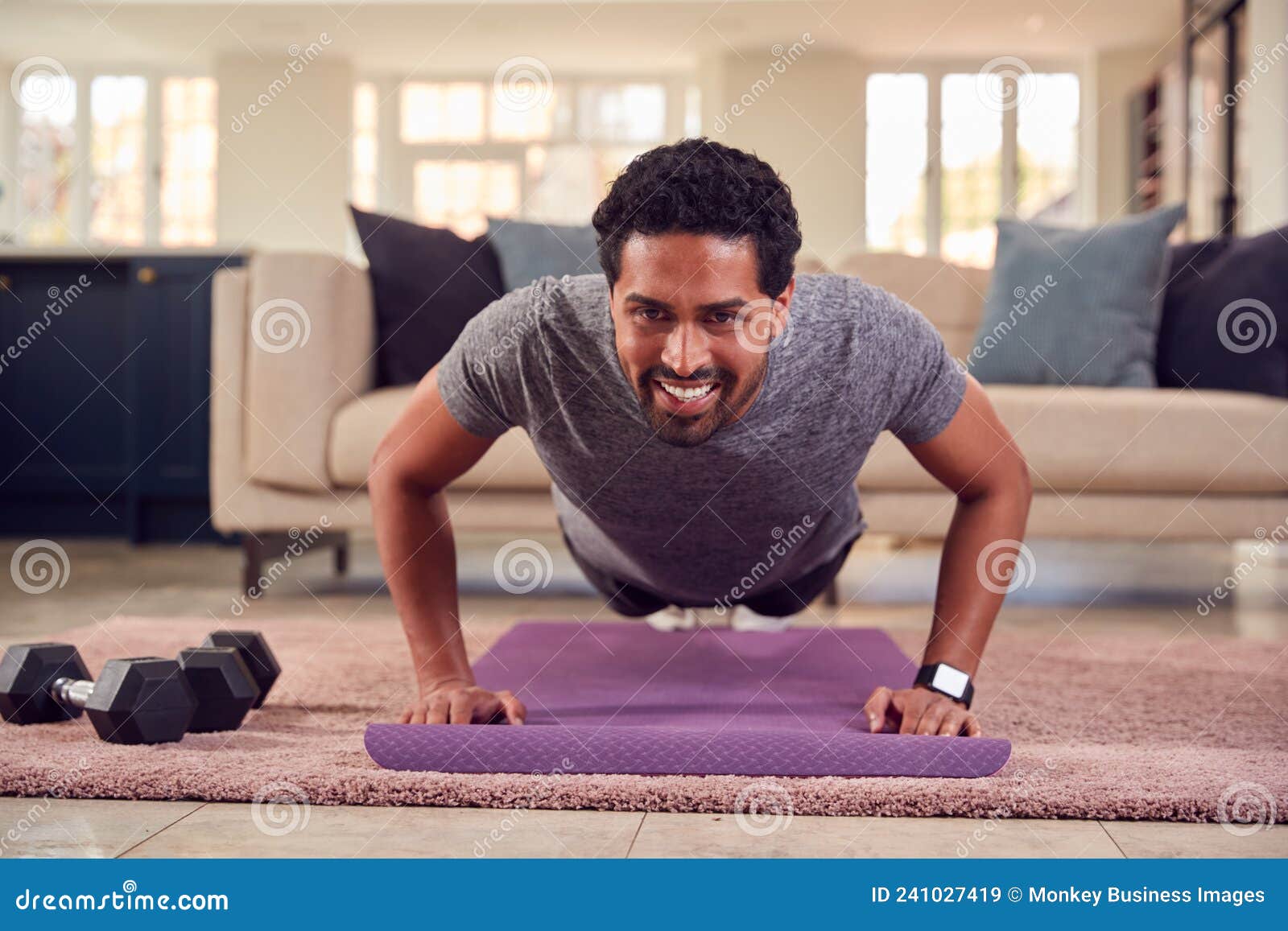 Man in Fitness Clothing at Home in Lounge Doing Press Ups and