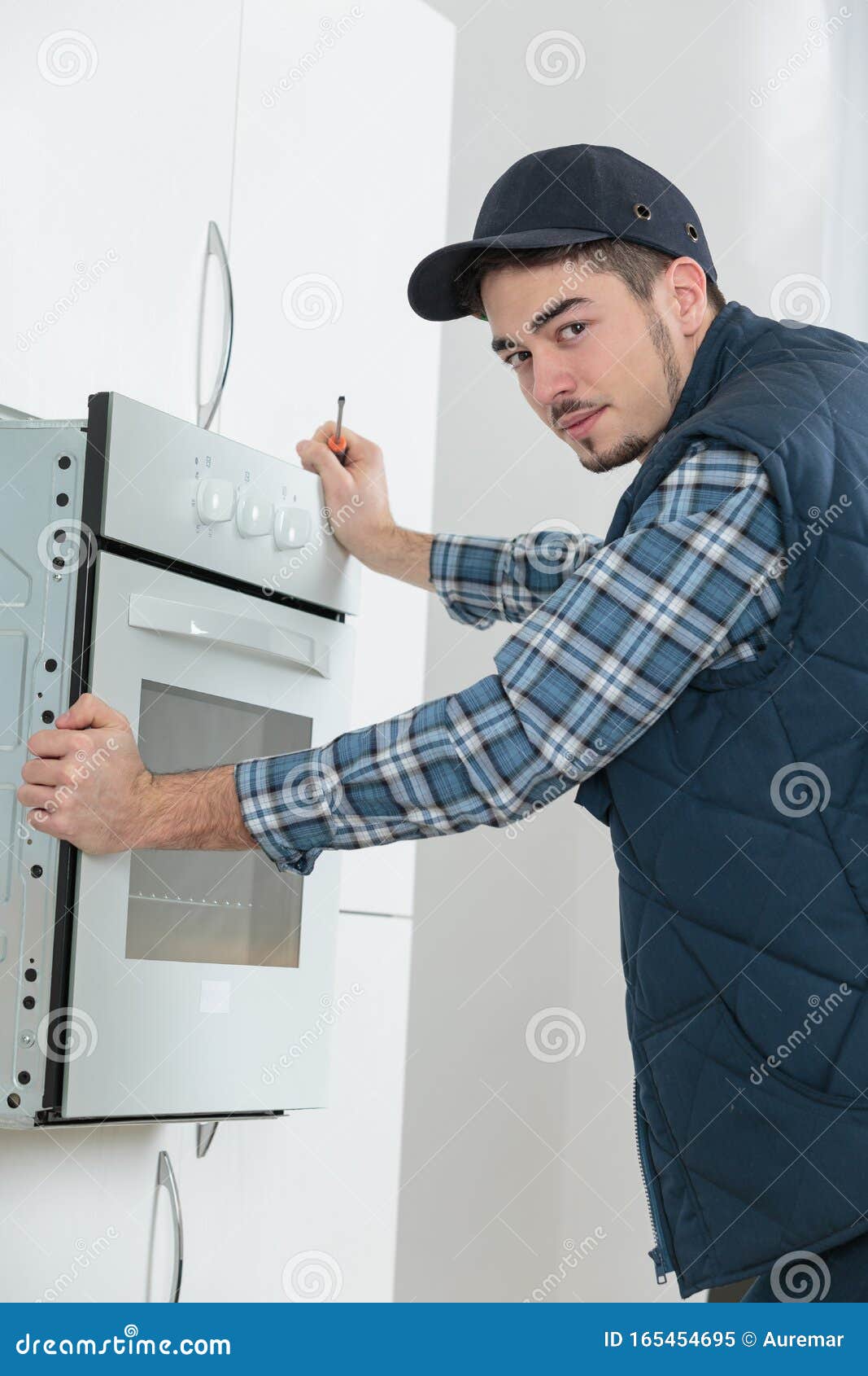 Man Fitting Oven in Kitchen Stock Image Image of person, construction