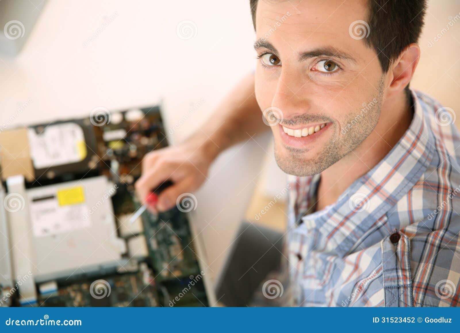 man fixing electronic appliance