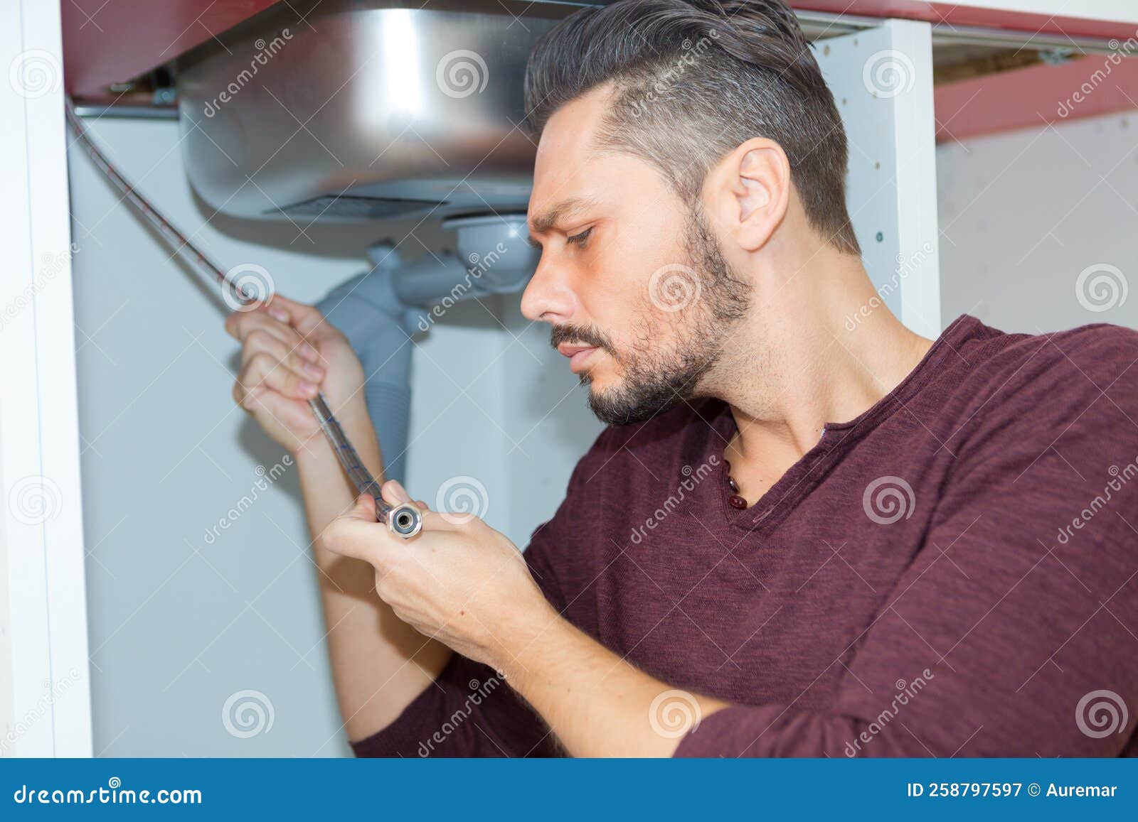 Man Fixing Pipes Under Sink Stock Image Image of leaking, underground