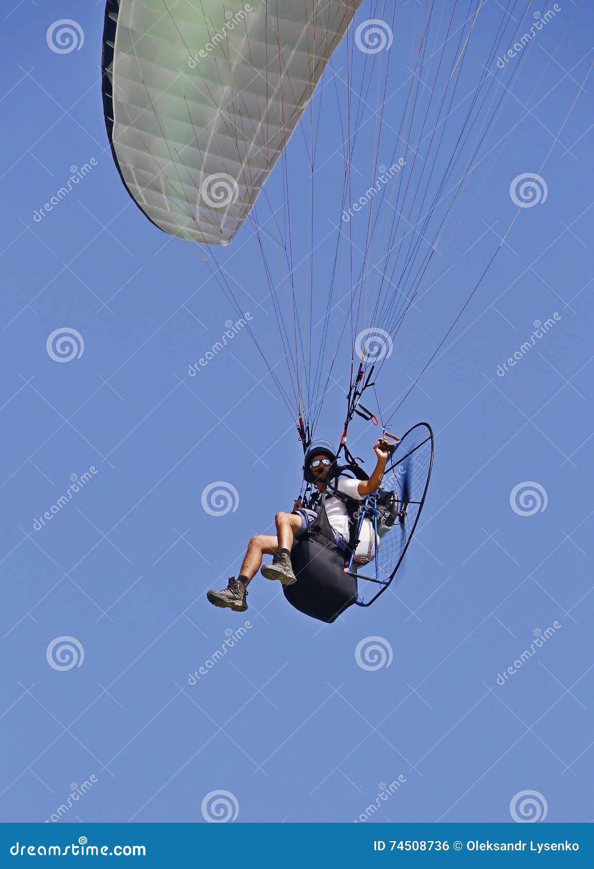 Man flying on a parachute stock photo. Image of parachute 74508736