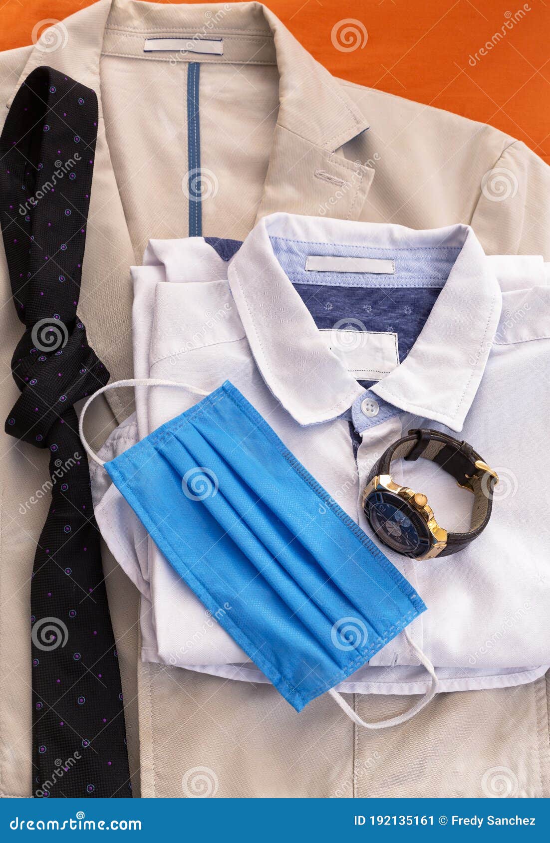man formal office outfit with a blue face mask. wearing face masks to prevent disease new normal concept. use of the face masks as