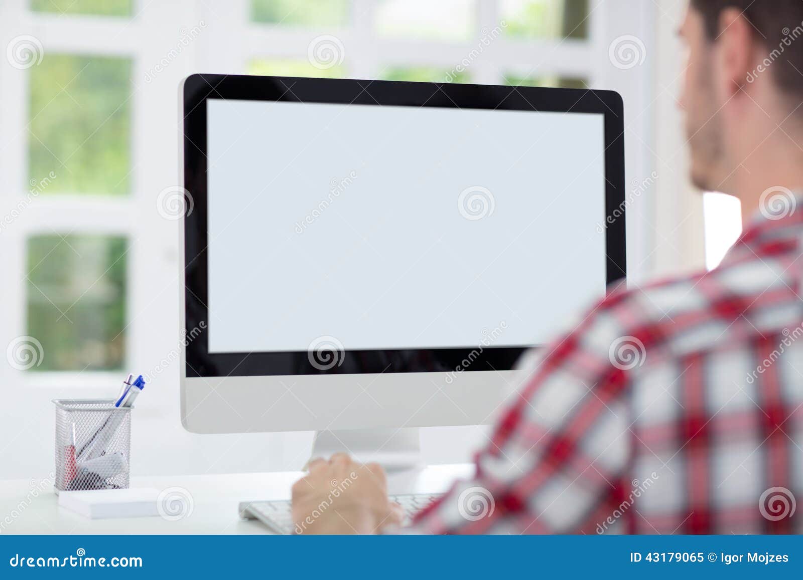 man in front of computer screen
