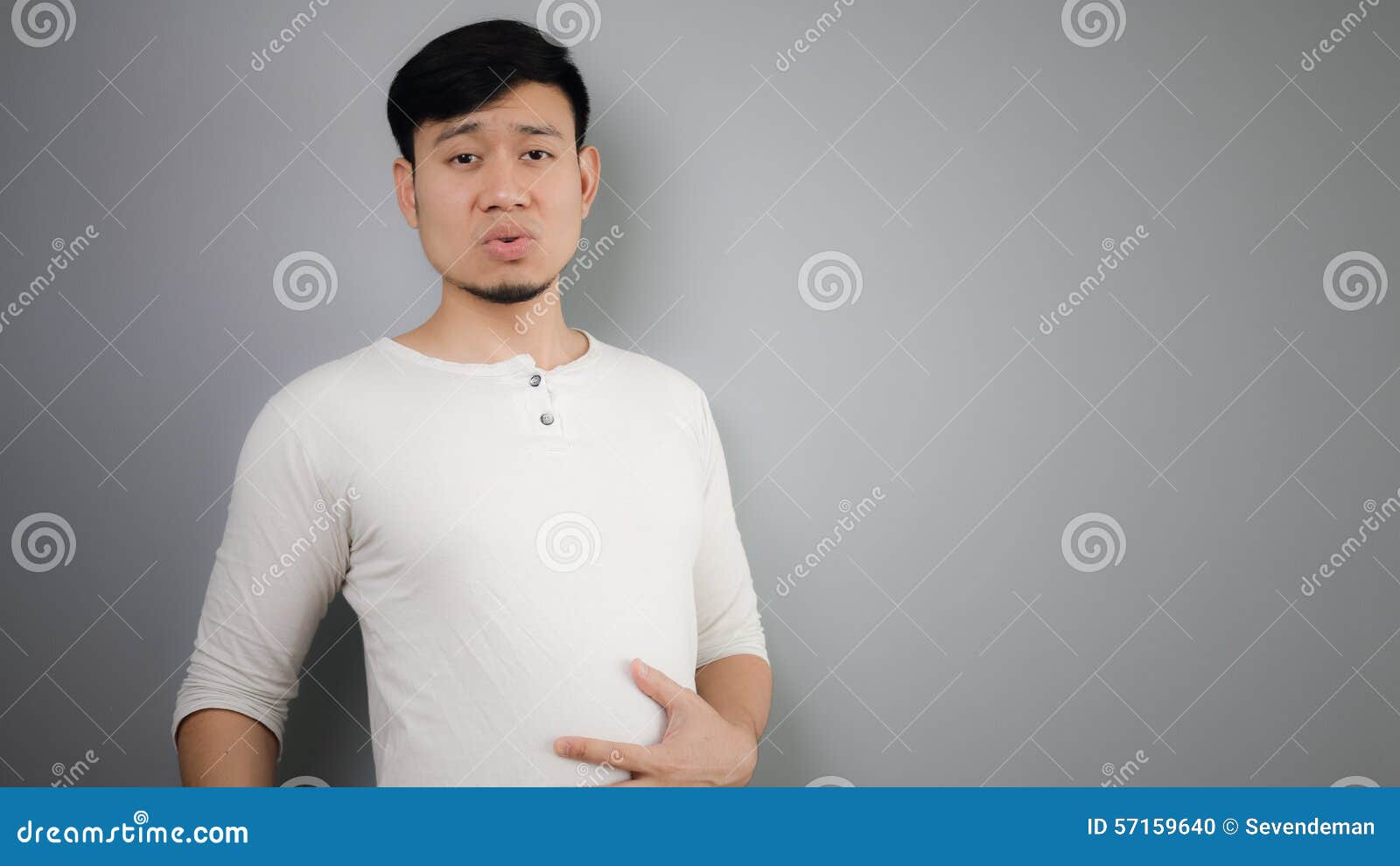 A man with full stomach. stock photo. Image of young - 57159640