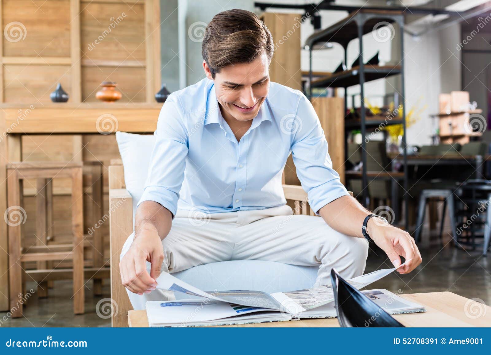 Man in Furniture Store Browsing Catalog Stock Image Image of customer