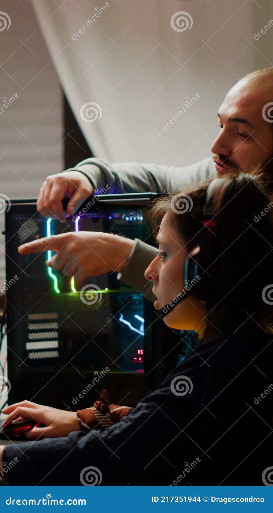 Man gamer teaching his girlfriend playing space shooter video game Stock  Photo by ©DragosCondreaW 465086788