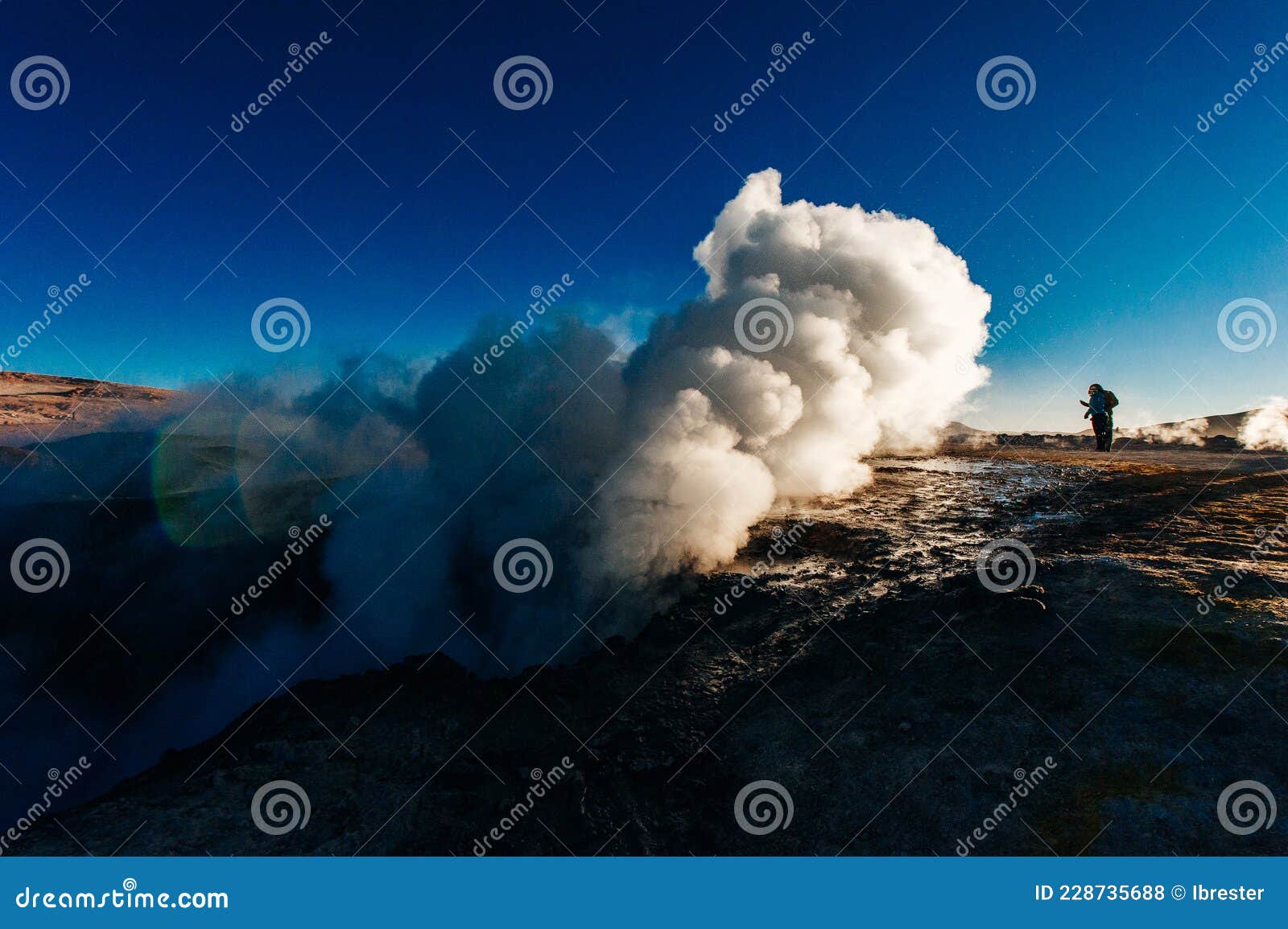 a man in the geysers at bolivian highlands sol de la manana, uyuni desert - december, 2018