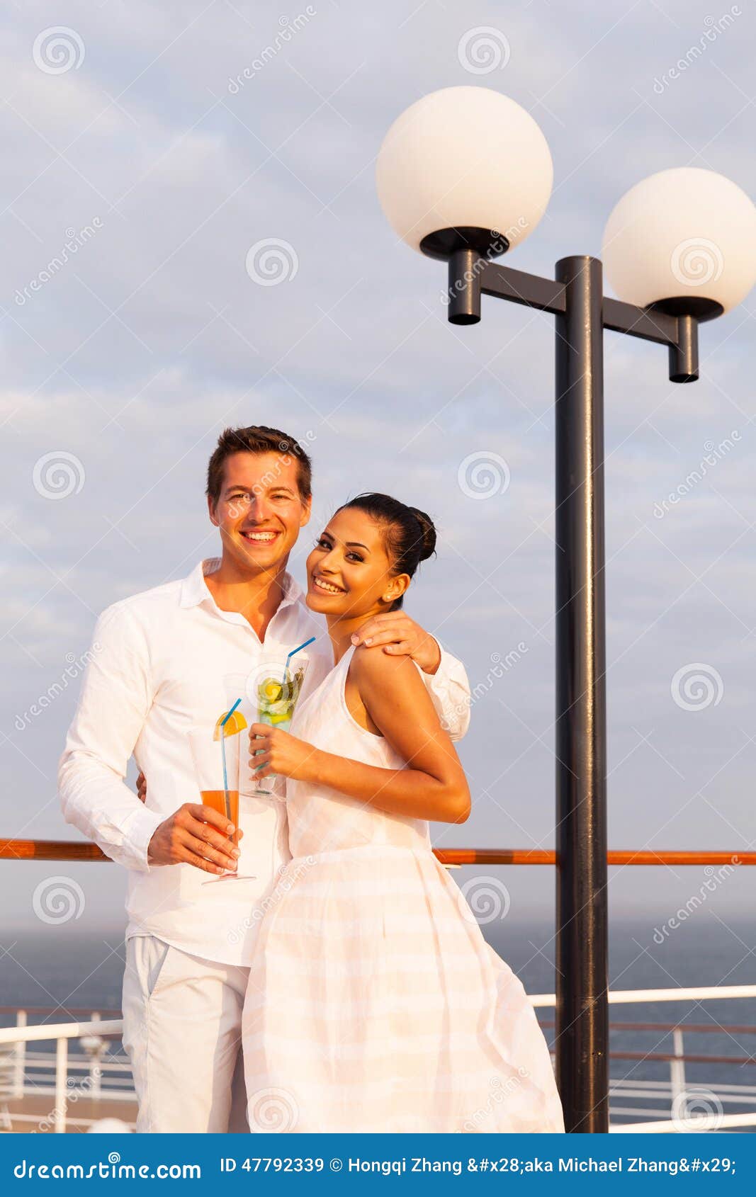 Man girlfriend cruise. Happy young men with girlfriend having drinks on a cruise ship