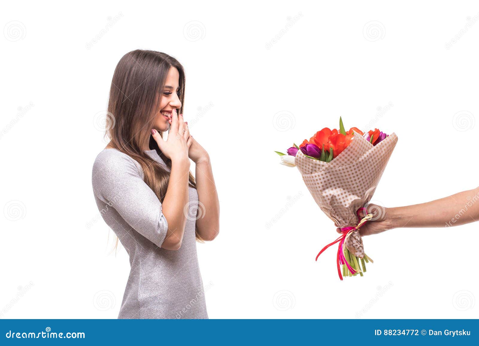 man giving a bunch of flowers and surprised woman 