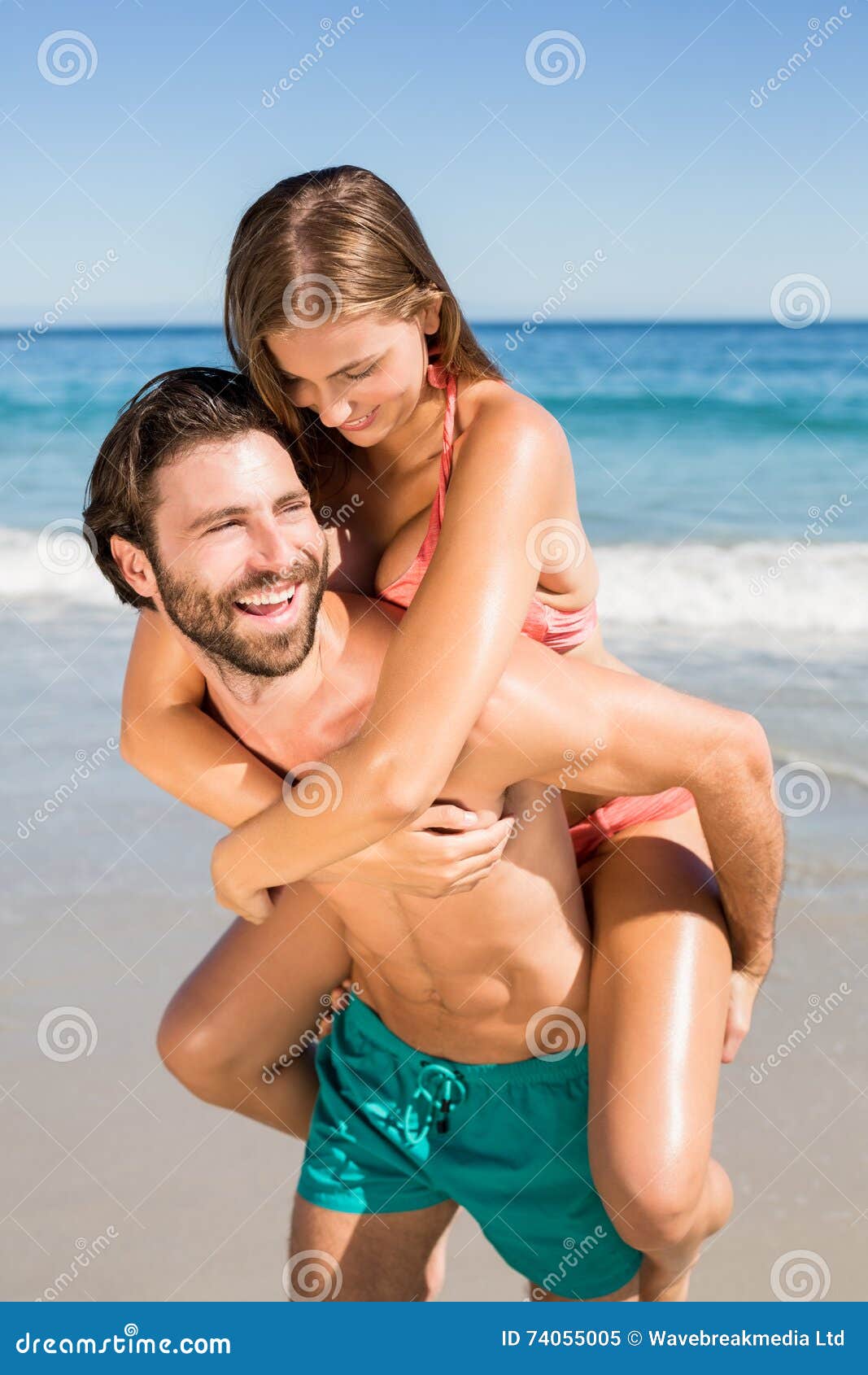 Free Photo  Man giving piggyback ride to woman on the beach