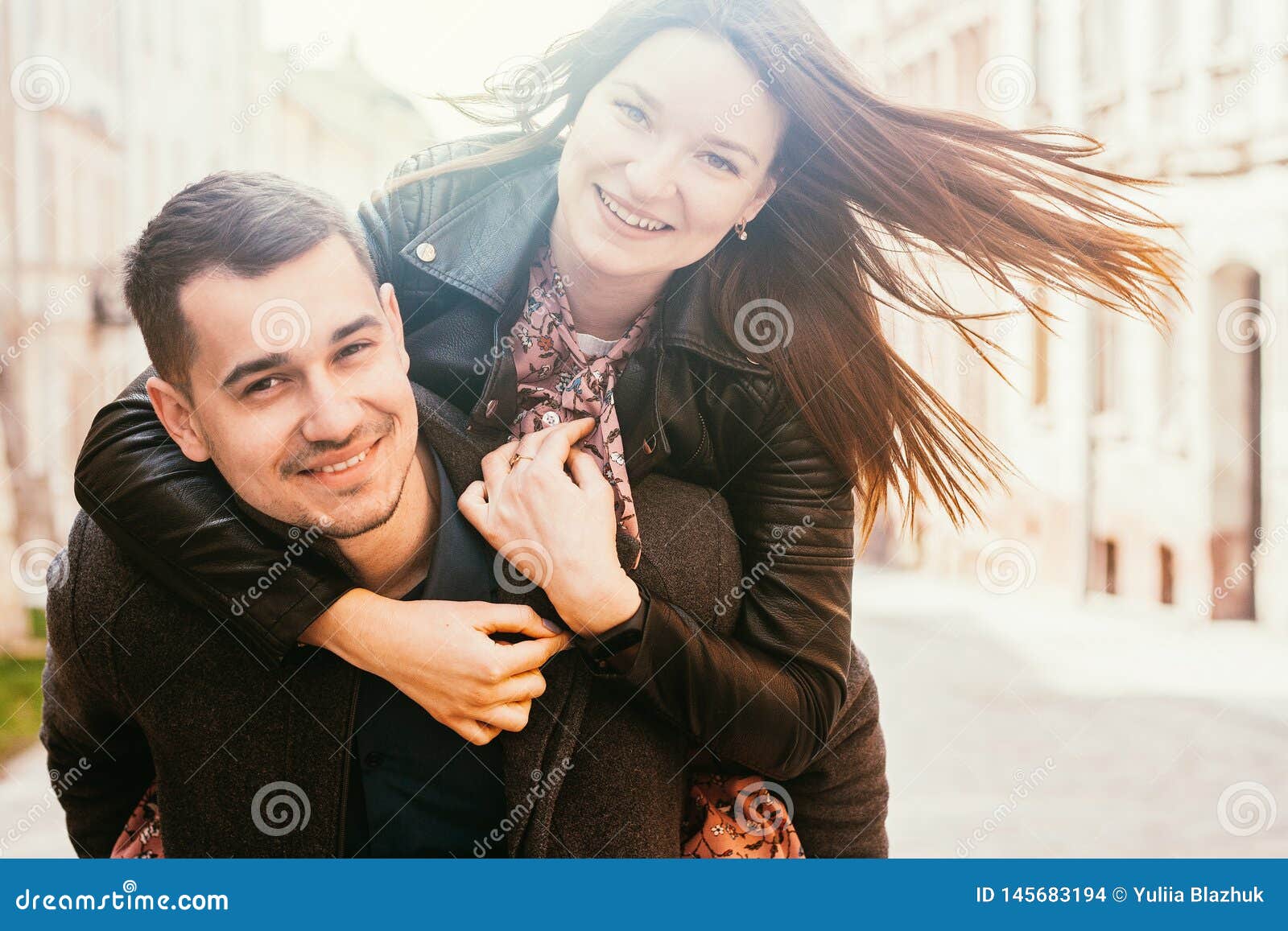 Man giving to girlfriend piggyback ride Stock Photo by ©gstockstudio  147713371