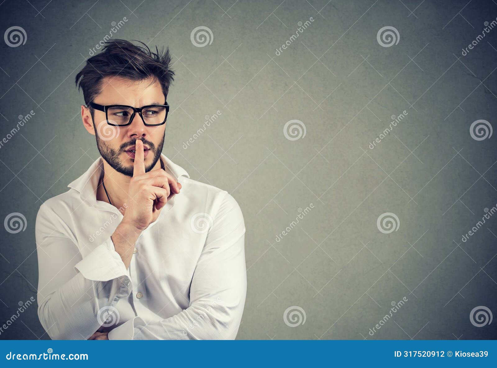 man giving a shh quiet finger to lips gesture