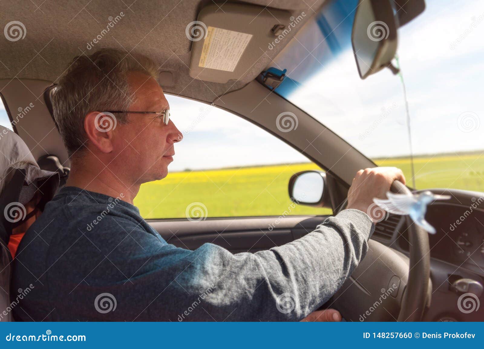A Man with Glasses Driving a Car. the Driver Drives the Car Stock Photo