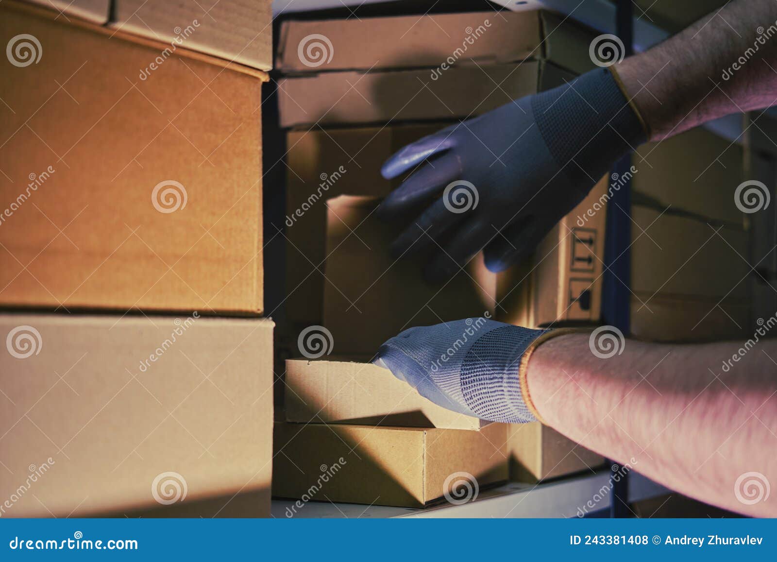 A Man in Gloves Steals Goods from a Box in a Warehouse. Problems with