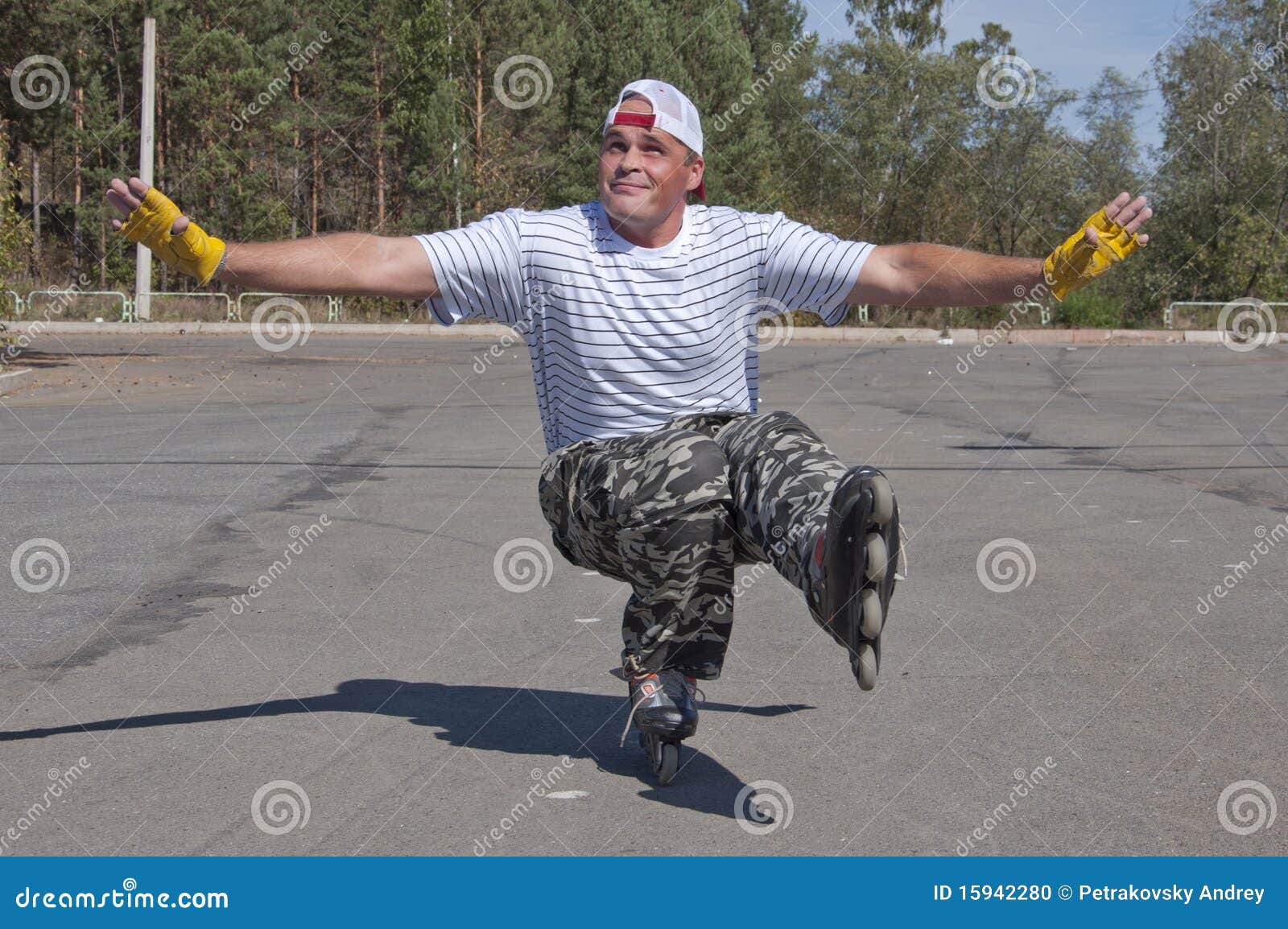 The Man Goes for a Drive on Roller Skates in a Sun Stock Photo Image