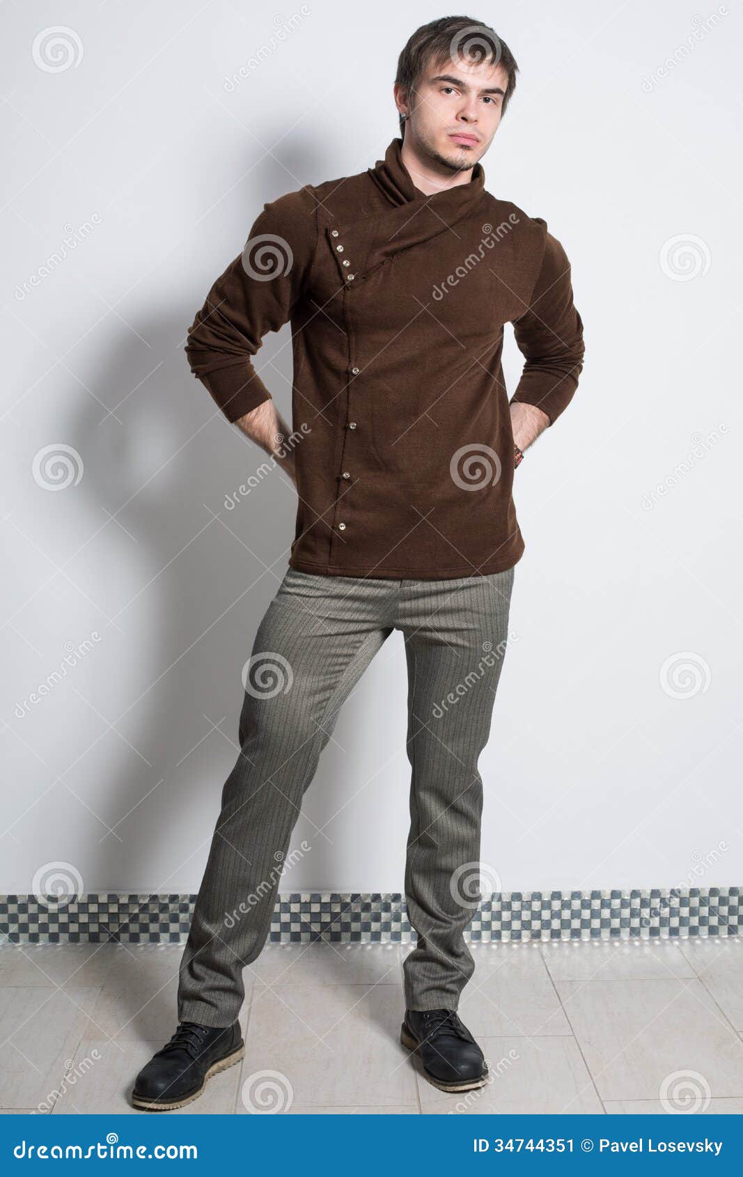 The Man In Gray Trousers And Fashionable Brown Sweater 