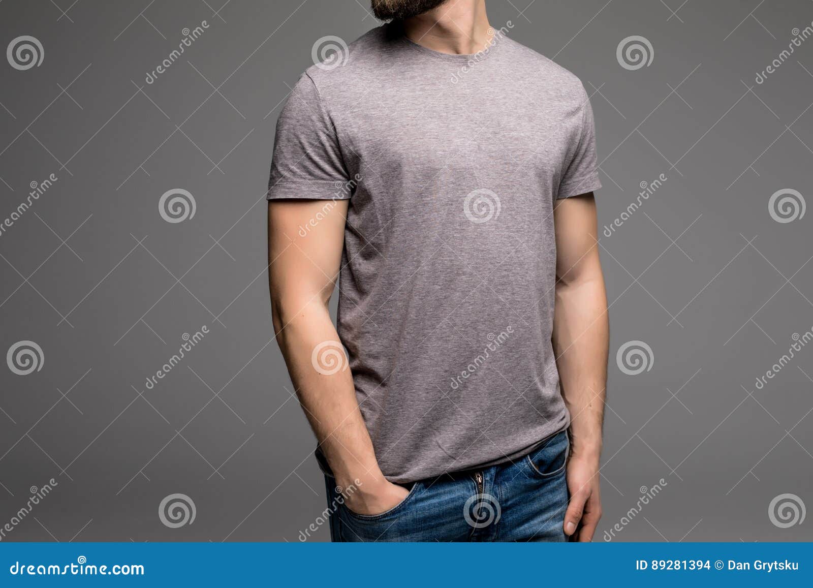 A Man in a Grey T-shirt and Denims Holds His Hands in Pockets. Stock ...