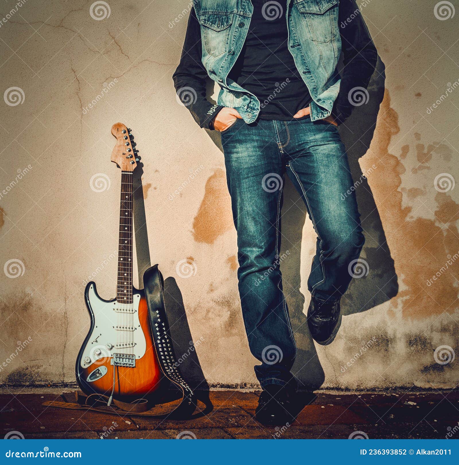 Man and Guitar Leaning on a Grunge Wall Stock Photo - Image of ...
