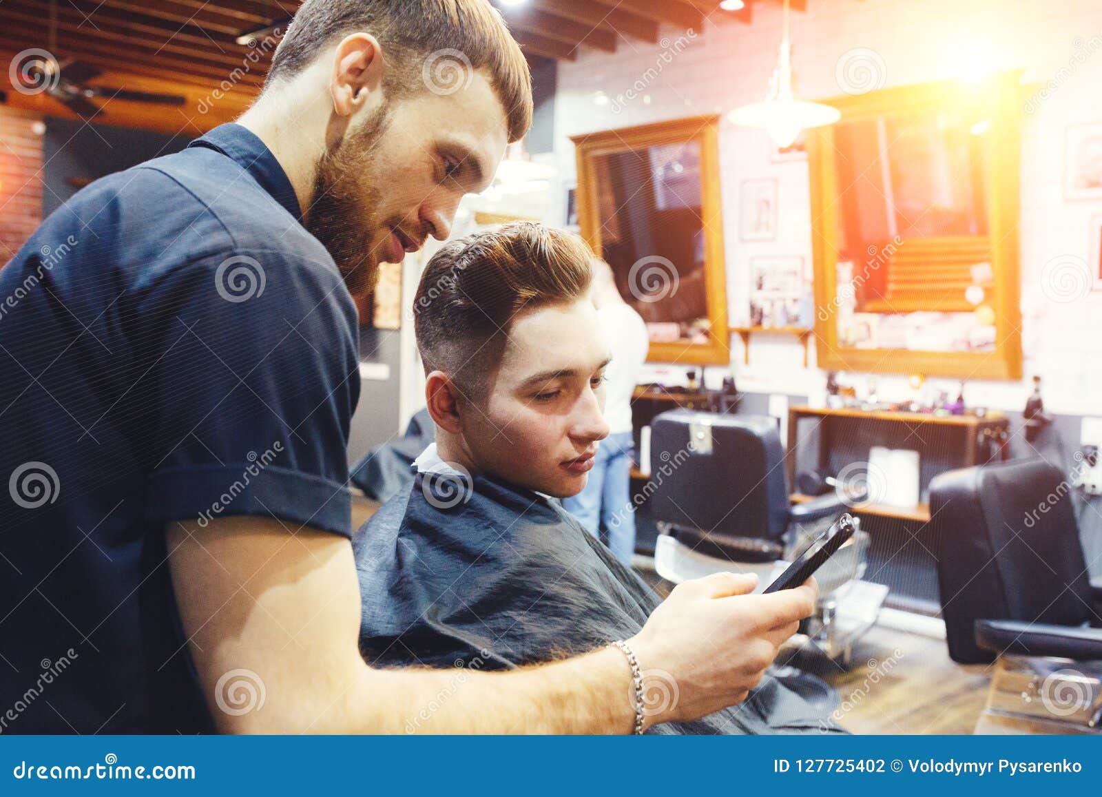 Man At The Hairdressing Salon Hairstylist With Client Choosing A