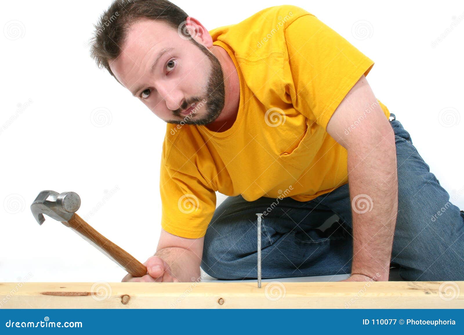 Man Hammering in Nail stock image. Image of jean, work 110077