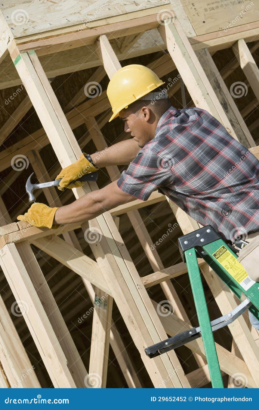 man hammering nail on wooden formwork