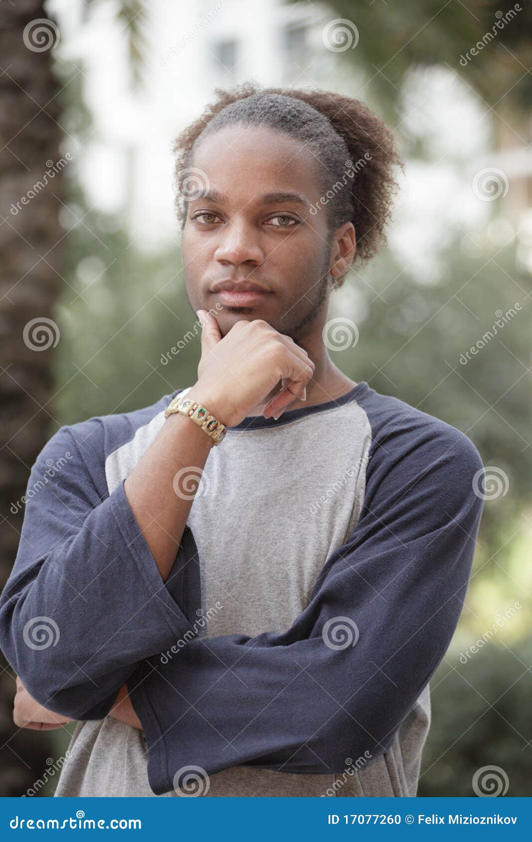 Man with hand on chin stock photo. Image of outdoors 