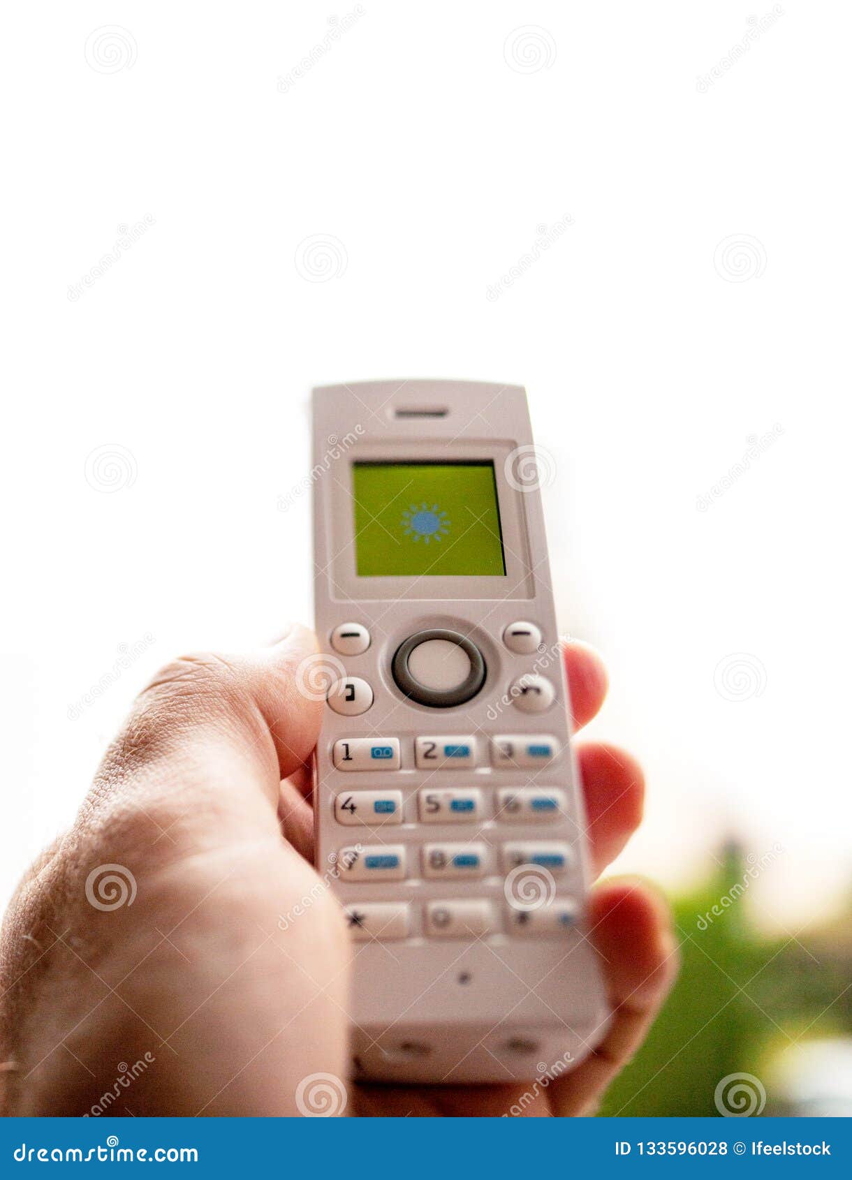 man hand holding cordless phone calling home office