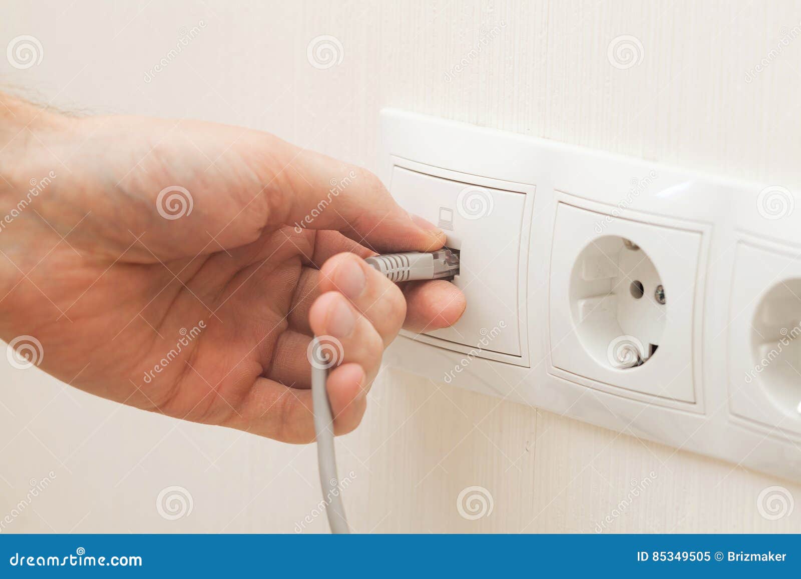 Man Hand Inserts the Network Cable To the Outlet. Stock Image
