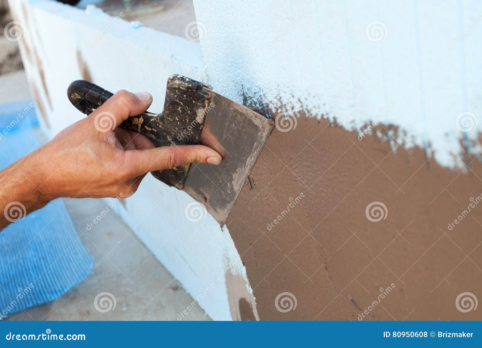 Man Hand with Trowel Plastering a Wall. Stock Photo Image of skim