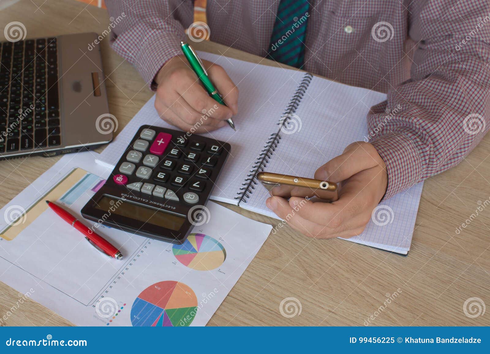 man hand using calculator and writing make note with calculate about cost at home office. the man and computer are using a calcula