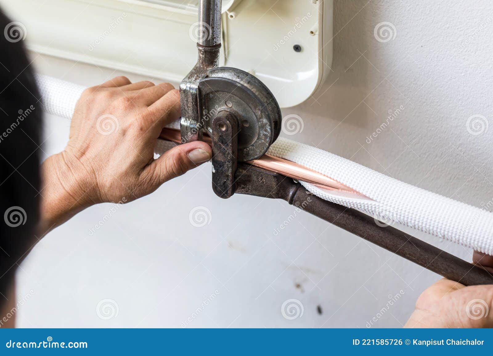 Man Hands Bends Copper Pipes by Pipe Bender. Air Conditioner Technician