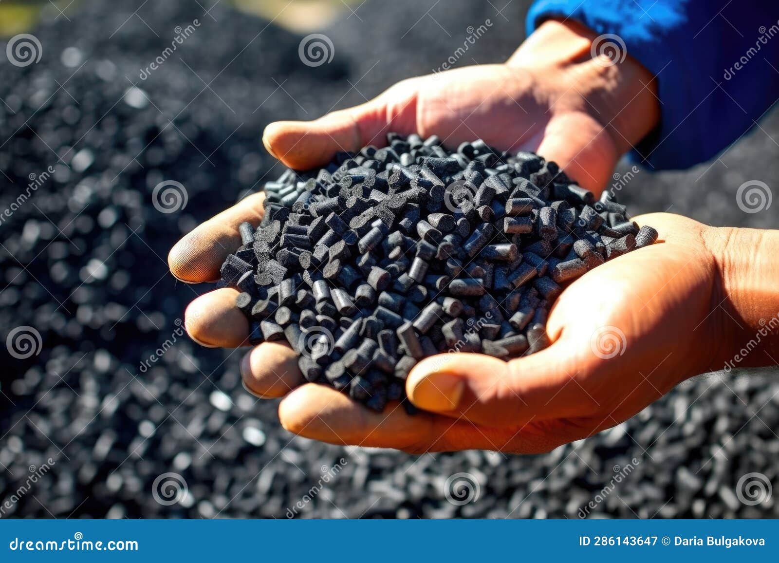 man hands hold black granules biochar pellets. handful of charcoal pellets fuel in a person hands. organic biochar derived made