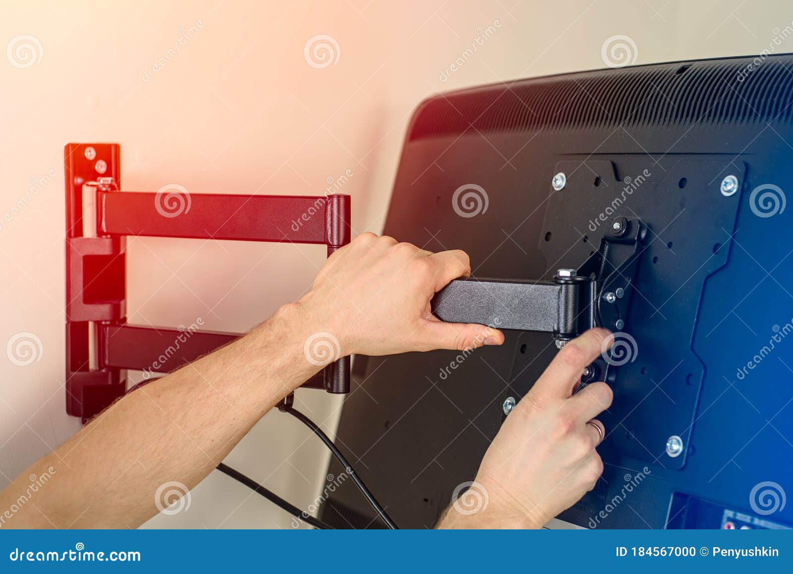 A Man Hands Install a TV Mount on a Wall Stock Photo Image of hang