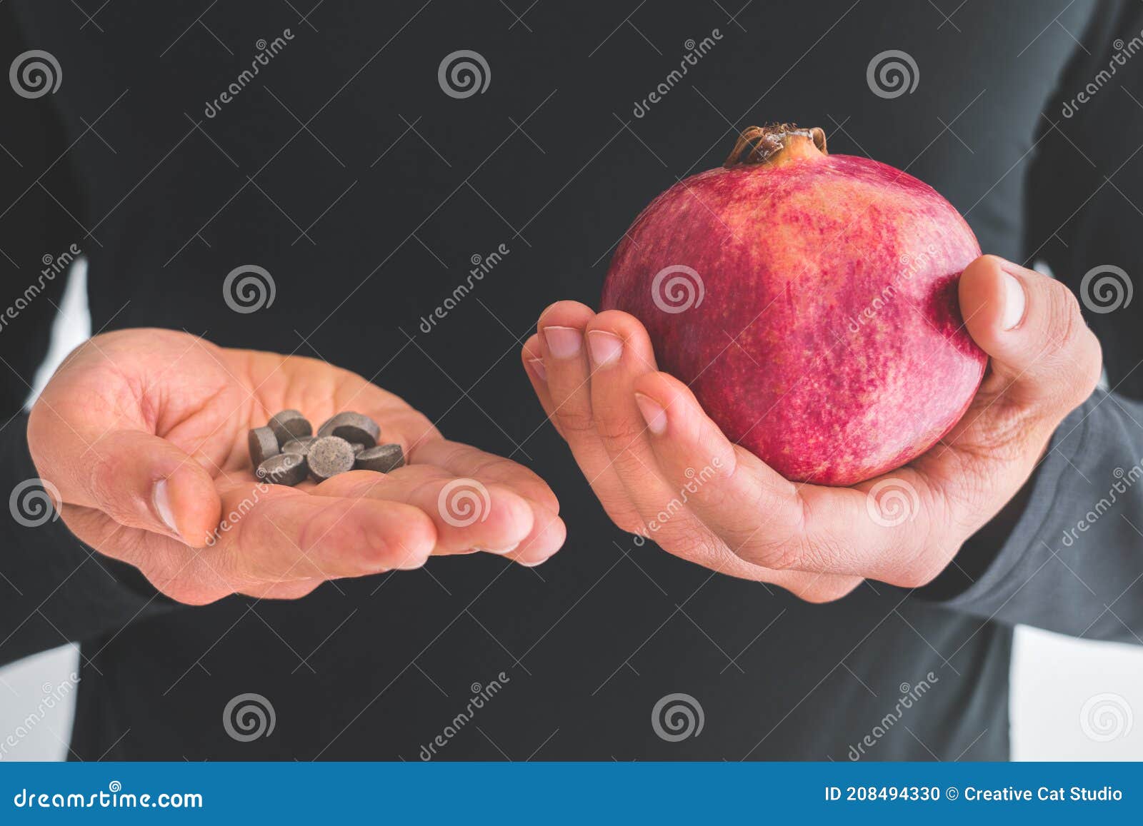 man hands with iron supplements and pomegranates to treat iron deficiency anemia