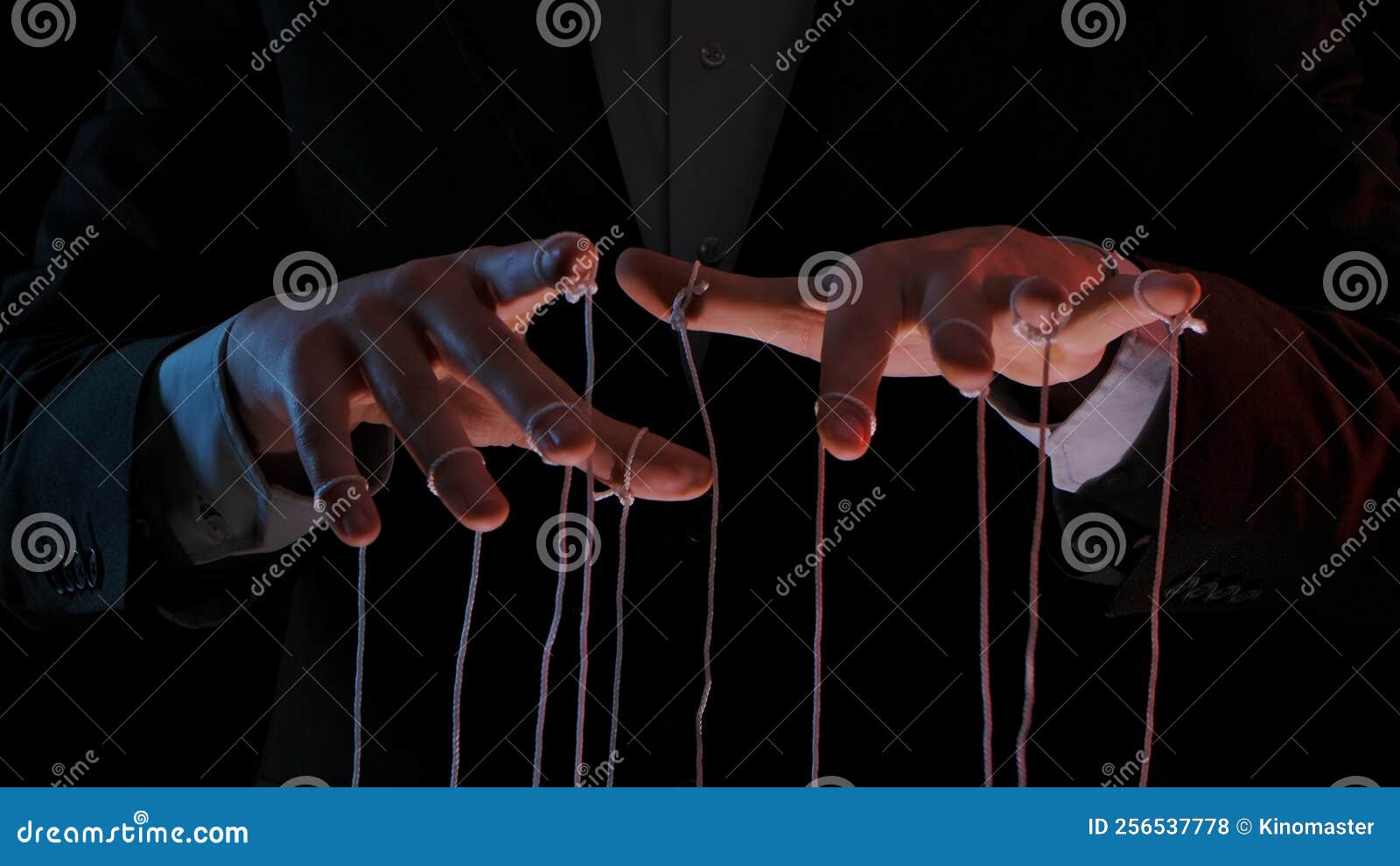 man hands with strings on fingers. hands close up pulling strings. man in business suit manipulates puppet. puppeteer