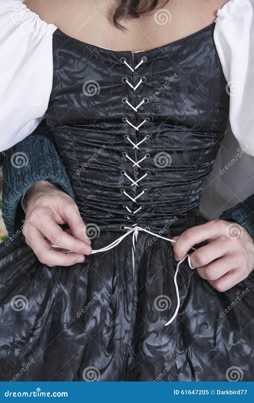 Man Hands Untying Corset of Woman in Medieval Dress Stock Image