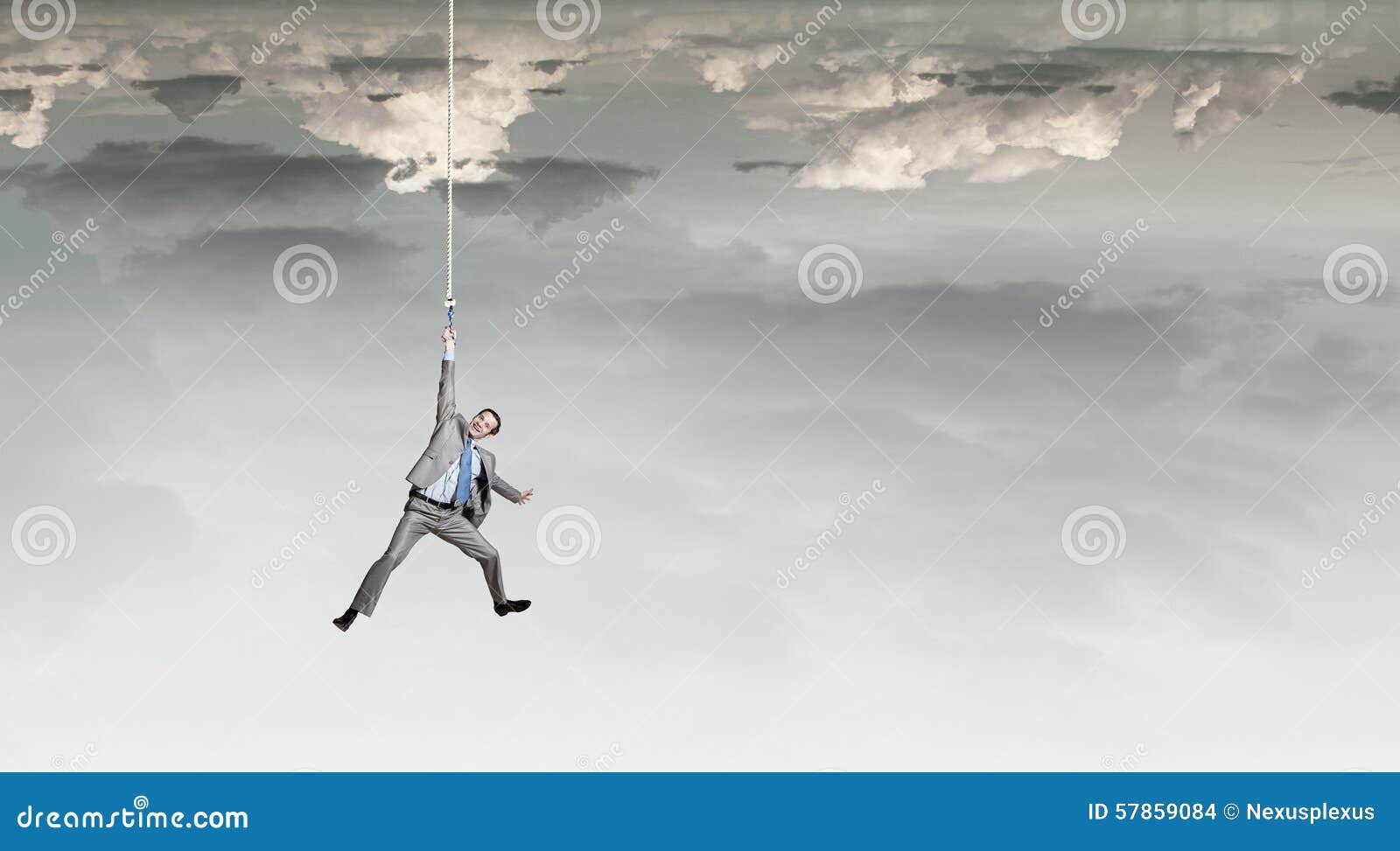 courageous man hanging on a steel wire Stock Photo